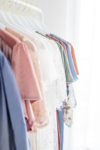 A rack of dresses in pastel colors