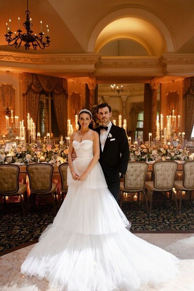 Couple posing in front of reception tables taken by naples florida wedding photographer
