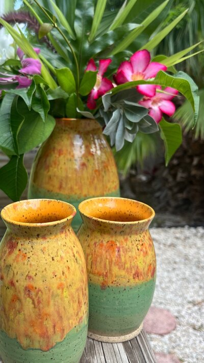 Three yellow and green vases sit on a table in Key West FL. The vases were a part of Mango Madness Annual Members' Exhibition at the Studios of Key West