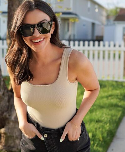 Tiara Rachel with her hands in her pocket and sunglasses on