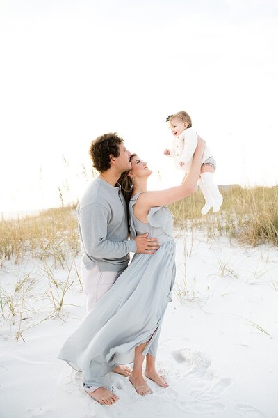 a well-dressed and  happy family enjoying family time at a Destin beach with their photographer