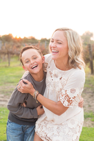 mom and son laugh as they take family holiday photos in clovis california