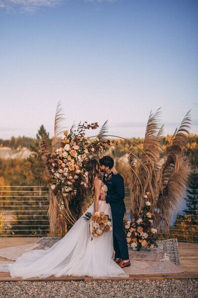 Pampas grass and string lights at River's Edge, a picturesque country wedding venue in Devon, Alberta, featured on the Brontë Bride Blog.