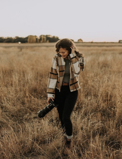 Wedding and Elopement Photographer, Breanne Gomez holding camera with her hand in her hair