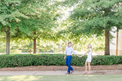 Engaged Couple walking and holding hands at Jule Collins Smith Museum  | Auburn AL Wedding Photographer Amanda Horne