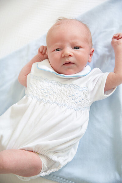 Baby in white embroidered onsie