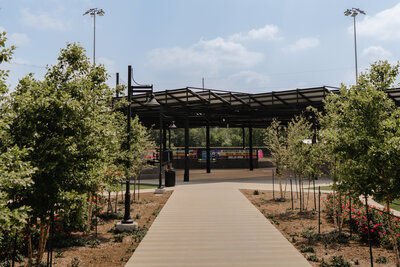 sidewalk leading to shade structure at little league field