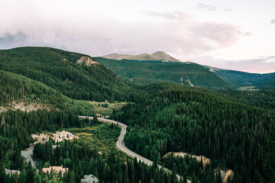 Summer mountain view with winding road and lush, green trees in Breckenridge, Colorado