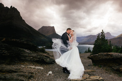emily and jason embracing in front of mountains
