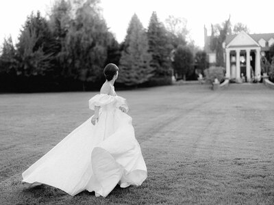 bride running on lawn at oakshire estate and airfield