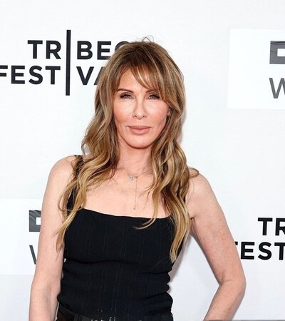 Kerrently Standing by a wall in a black jumpsuit
