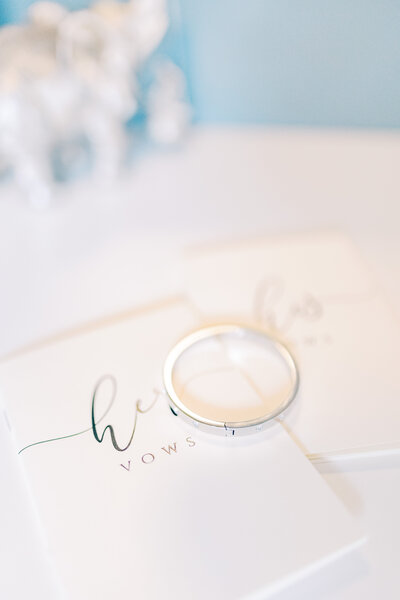 Close up of wedding rings and vow books