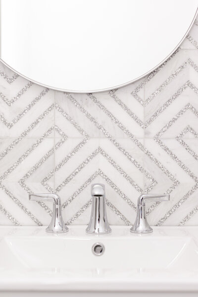 The bathroom features Carrera Bella marble paired with gray terrazzo tiles.