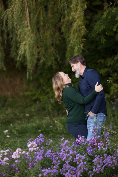 couple looking at each other and laughing during family pictures in boise with Tiffany Hix