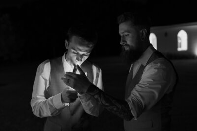 groom smoking cigar at wedding