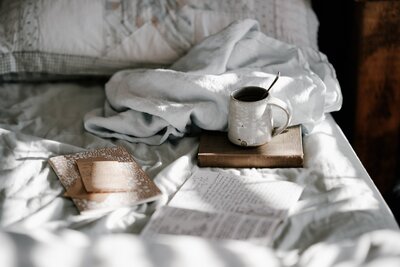 Journal and coffee on the bed