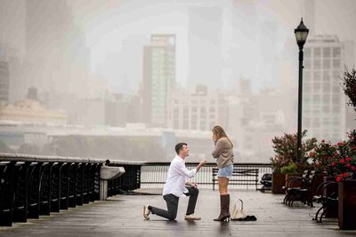 Rainy day proposal at Pier 13 in Hoboken, captured by NJ engagement photographer Alex Kaplan