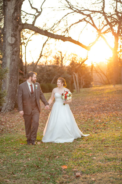 The groom is leading the bride for couples portraits at Historic Tuckahoe in  Richmond, VA.