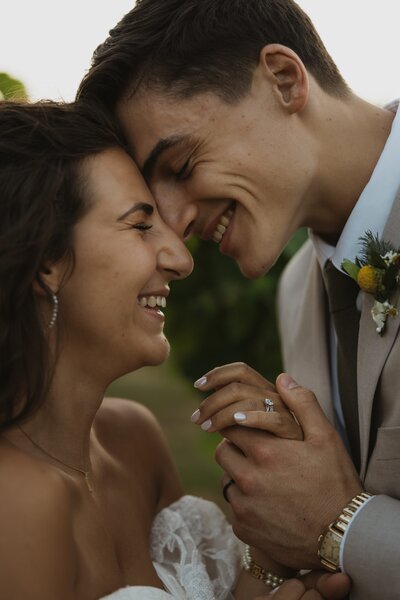 close of photo of bride and groom touching foreheads