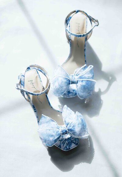 Blue floral brides shoes taken in window light at a wedding in Michigan