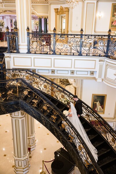 new york wedding planner image if couple walking up dark staircase