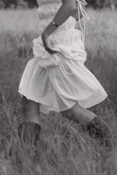 A woman running angelically running through a field
