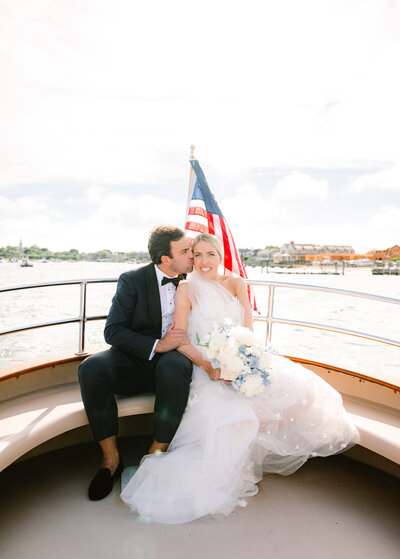 Luke kisses Hannah on a boat ride over to their reception