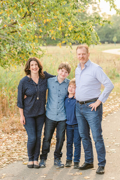 Family of four with big kids at a Forest Park meadow for their Chicago Family photos