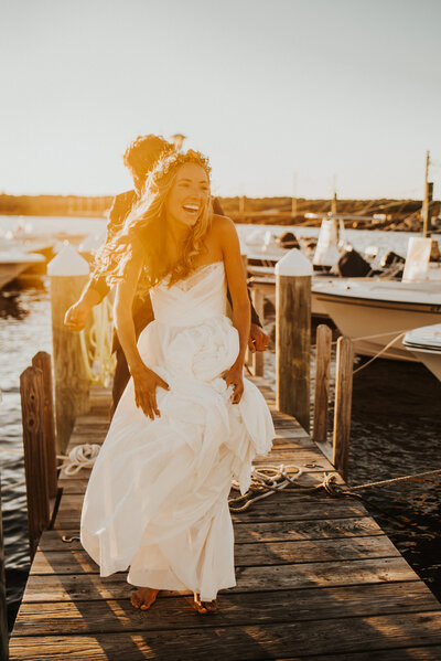 bride and groom on a dock at sunset in New England
