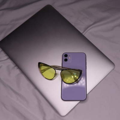 Amandas essential laptop, cool mom sunglasses, and purple iphone.