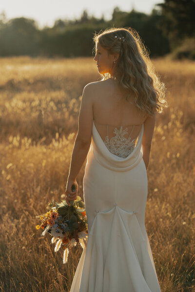 details of the back of the brides wedding dress during wedding portraits in Comox by Latitude 49 Photography