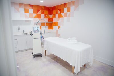 Medical Spa Treatment Room with Organge & White Wall Design