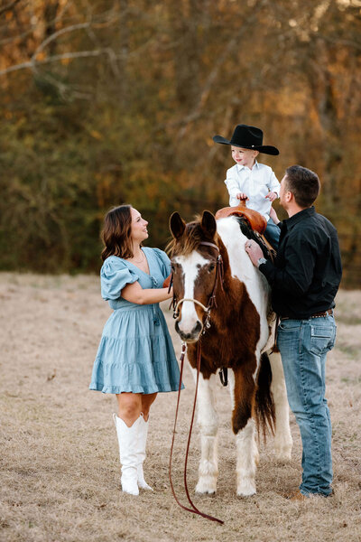 candid family picture on East Texas ranch with family and horse