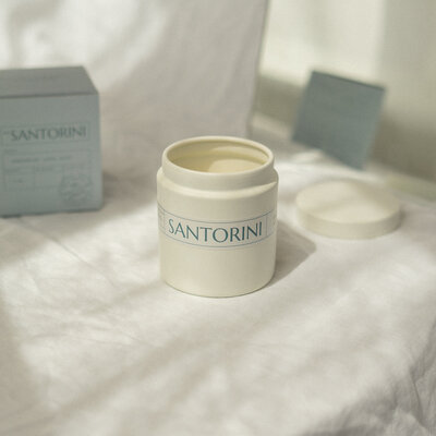 Santorini travel themed candle with wood wick and natural soy in a reusable container