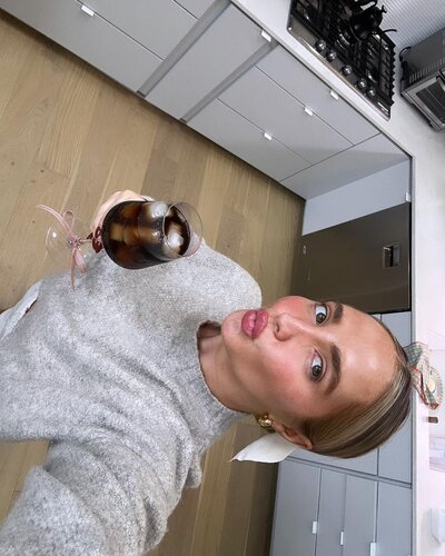 A selfie of Kenzie raising a glass in cheers