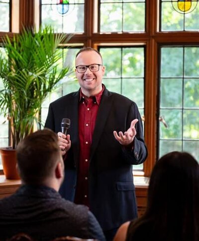 Experience the tailored guidance of Dr. Mike, shown here speaking before an audience.