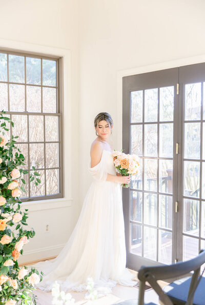 Beautiful bride surrounded by stunning windows pouring in natural light during bridal portraits at Virginia Wedding Venue. Captured by Charlottesville Wedding Photographer Bethany Aubre Photography.