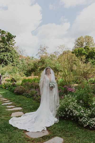 Bride poses in garden wedding