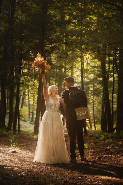 Celebrating their elopement on a hiking trail in Lake Placid.