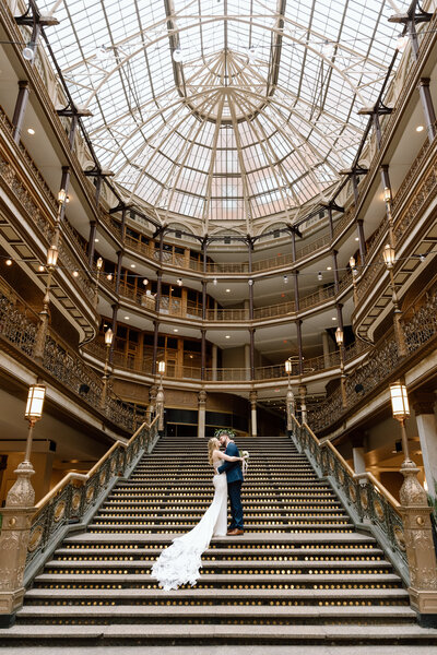 Bride and groom on the steps of the Arcade in Cleveland.