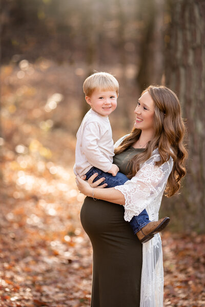 Pregnant mother holds her son during a maternity photoshoot near Birmingham