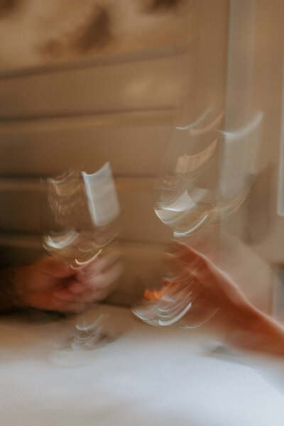 blurred photo of champagne glasses celebrating engagement photo