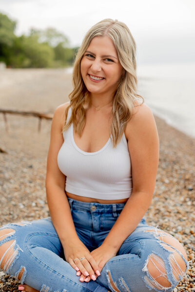 girl sitting on beach smiling
