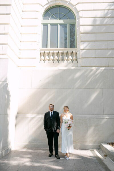 Bride and groom in front of wedding venue, by photographers in orlando fl