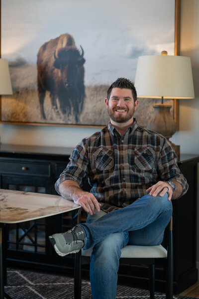 man with plaid shirt sitting at a table