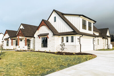 limestone and white board and batten house exterior