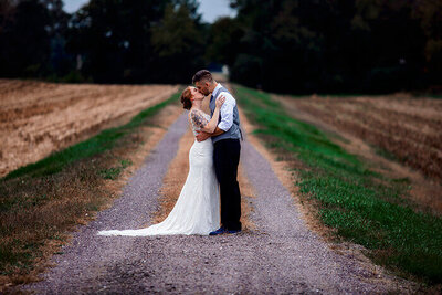 bride-groom-kiss-gravel-road