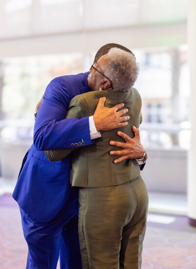 a man and woman hugging at an event