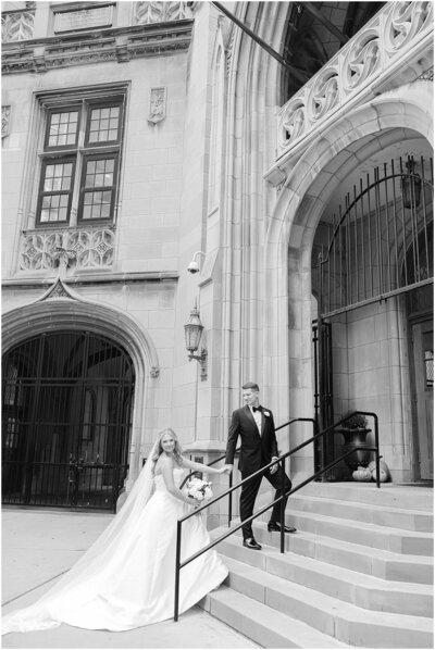 Elegant black and white wedding portrait of bride and groom outside of St. James Chapel in Chicago