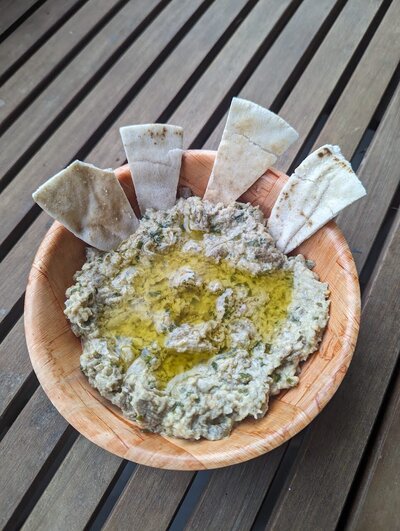 Mutabal is a delectable Middle Eastern dip made from roasted eggplants blended with tahini, garlic, lemon juice, and olive oil, creating a creamy and smoky flavor.